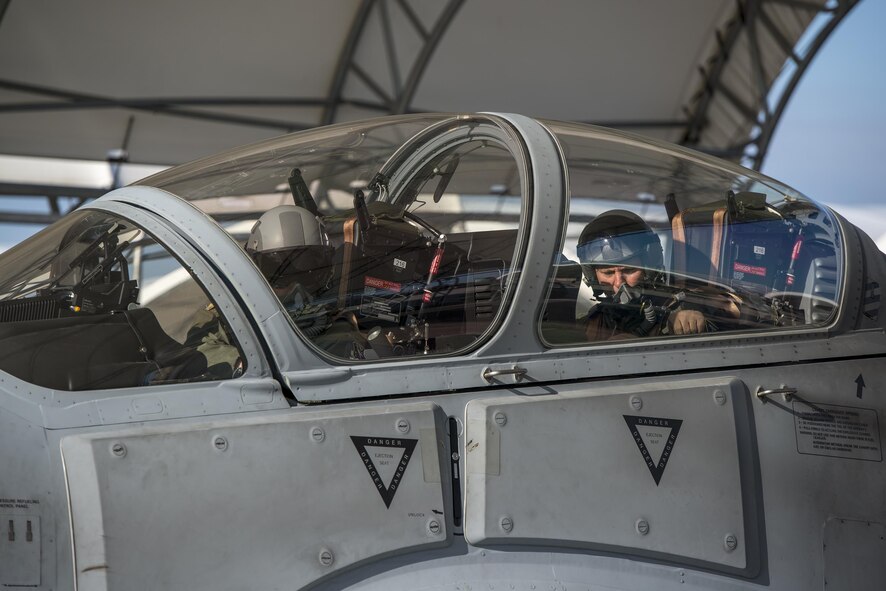 U.S. Air Force Col. Joseph Locke (right) 93d Air Ground Operations Wing commander, and a pilot from the 81st Fighter Squadron, close the canopy of their A-29 Super Tucano, June 23, 2016, at Moody Air Force Base, Ga. Locke is relinquishing command of the 93d AGOW to take a new position in Southwest Asia flying the A-29. (U.S. Air Force photo by Tech. Sgt. Zachary Wolf/Released)