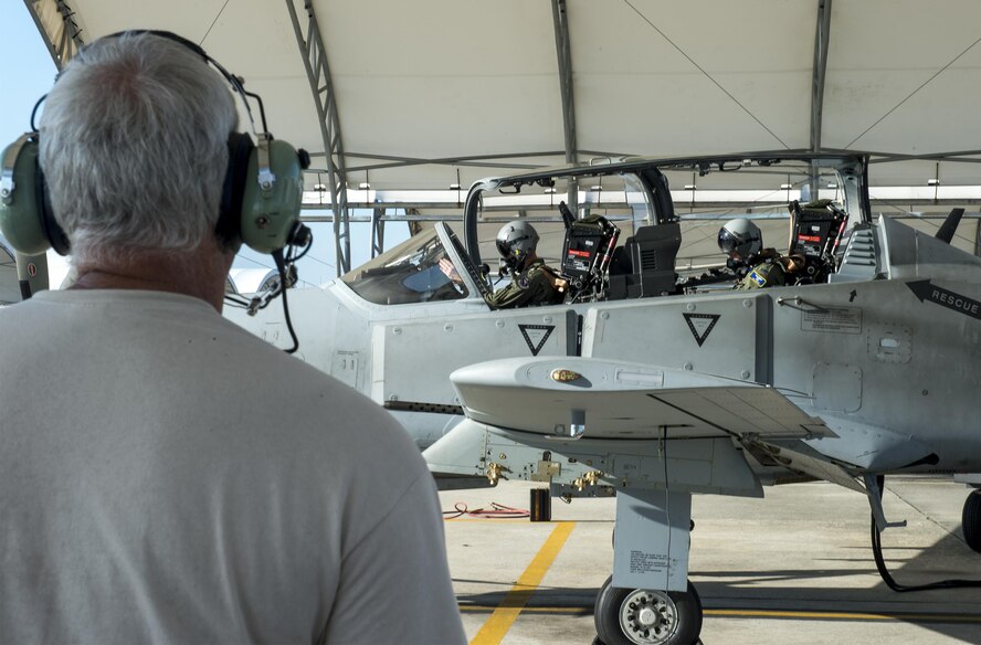 U.S. Air Force Col. Joseph Locke (right) 93d Air Ground Operations Wing commander, and a pilot from the 81st Fighter Squadron, perform preflight checks on an A-29 Super Tucano, June 23, 2016, at Moody Air Force Base, Ga. Locke flew to familiarize himself with the aircraft in preparation for his upcoming deployment. (U.S. Air Force photo by Tech. Sgt. Zachary Wolf/Released)