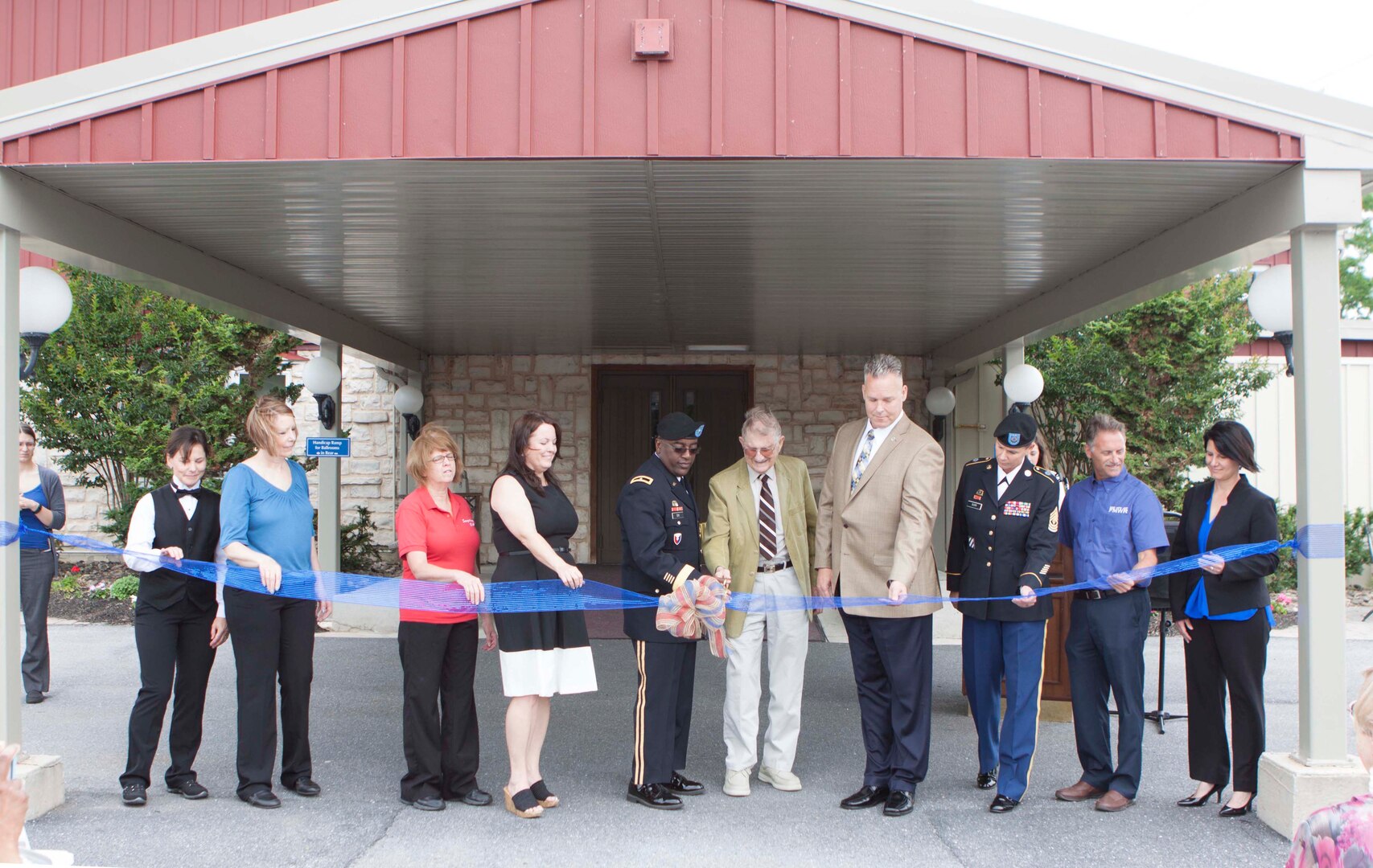 Ribbon-cutting participants included, from right to left, Susquehanna Club staff members Irma Gilke, Lisa Mitchell, Joann Burd, and manager Sharen Ewell; former DLA Distribution commander Army Brig. Gen. Richard Dix; former installation deputy Stephen Bosan; deputy site director Mike Lowe; installation senior enlisted leader Army 1st Sgt. Janine Burr; Family and Morale, Welfare and Recreation division chief, Jim Marshall; and FMWR business and recreation manager Dana Spalding.  