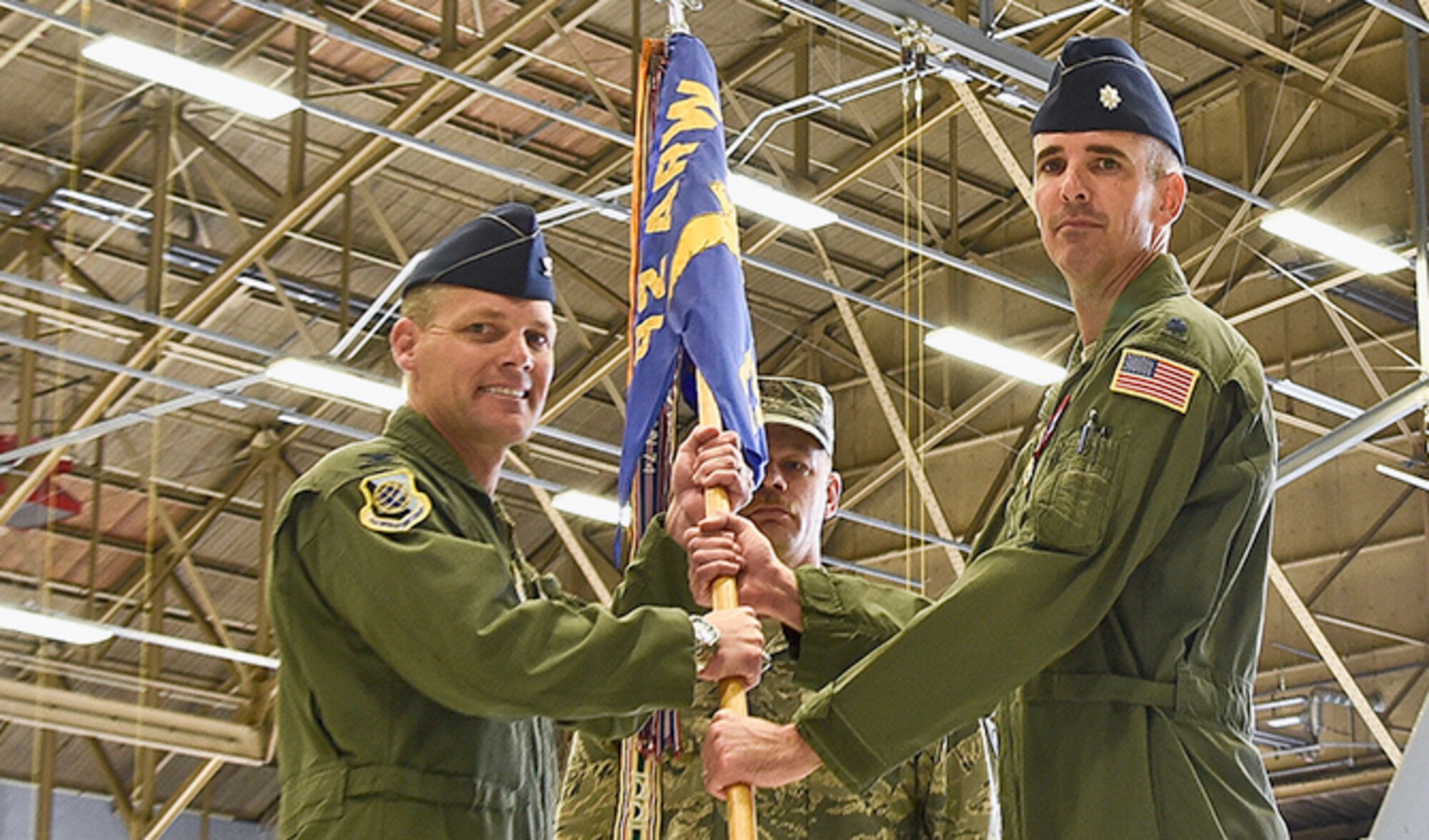 Col. Scott Gundlach, 92nd Operations Group commander, passes the 93rd Air Refueling Squadron guidon to Lt. Col. Jeremy Williams, 93rd ARS commander, during the change of command ceremony June 23, 2016, at Fairchild Air Force Base, Wash. Williams previously held the director of operations position for the 92nd ARS before moving to the 93rd ARS to become the commander. (U.S. Air Force photo/Airman 1st Class Taylor Shelton)