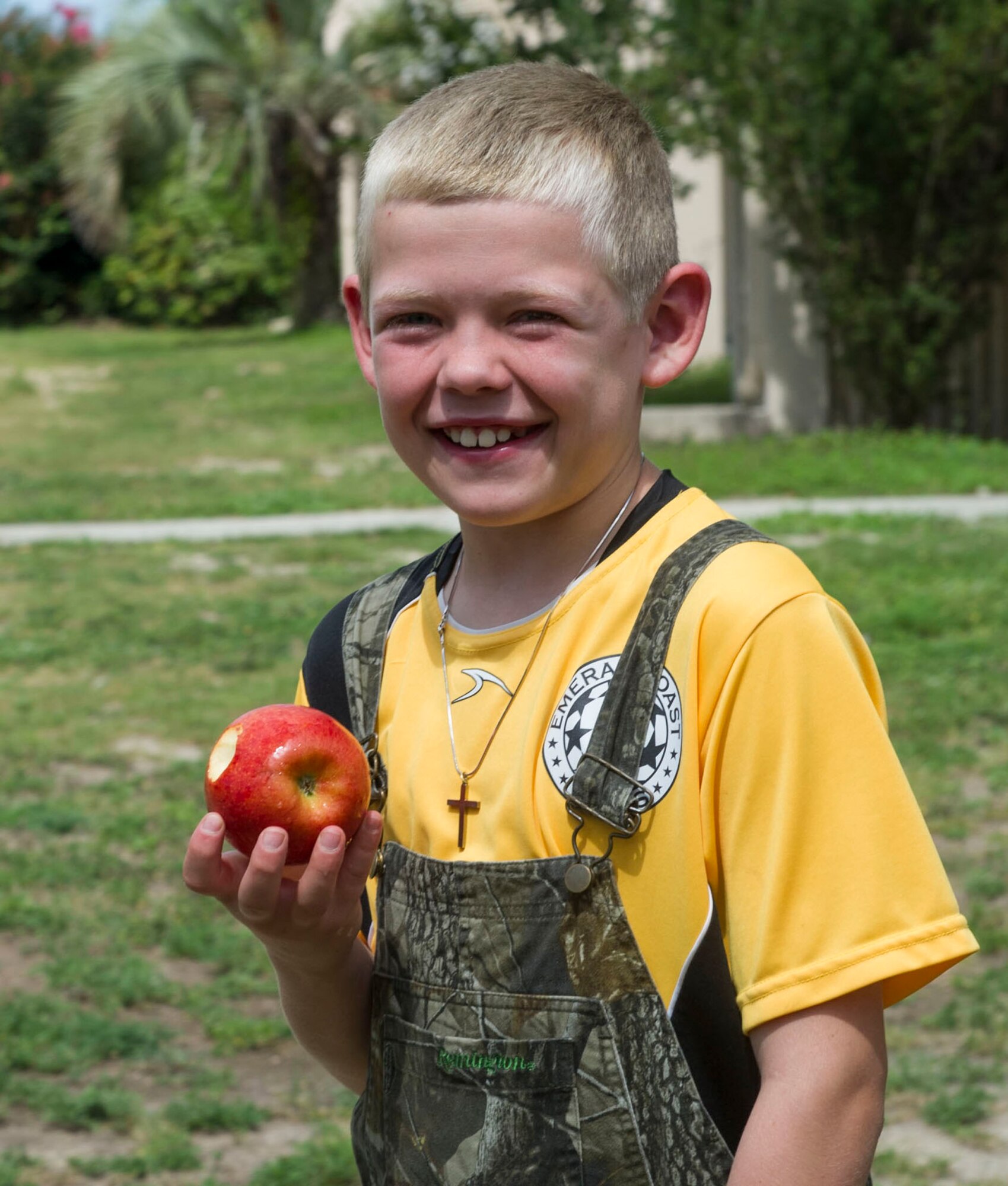 A child poses with an apple during a Summer Reading Program event at Hurlburt Field, Fla., June 23, 2016. During the event, children participated in physical activities while learning the importance of fruit and vegetable intake. (U.S. Air Force photo by Senior Airman Krystal M. Garrett)
