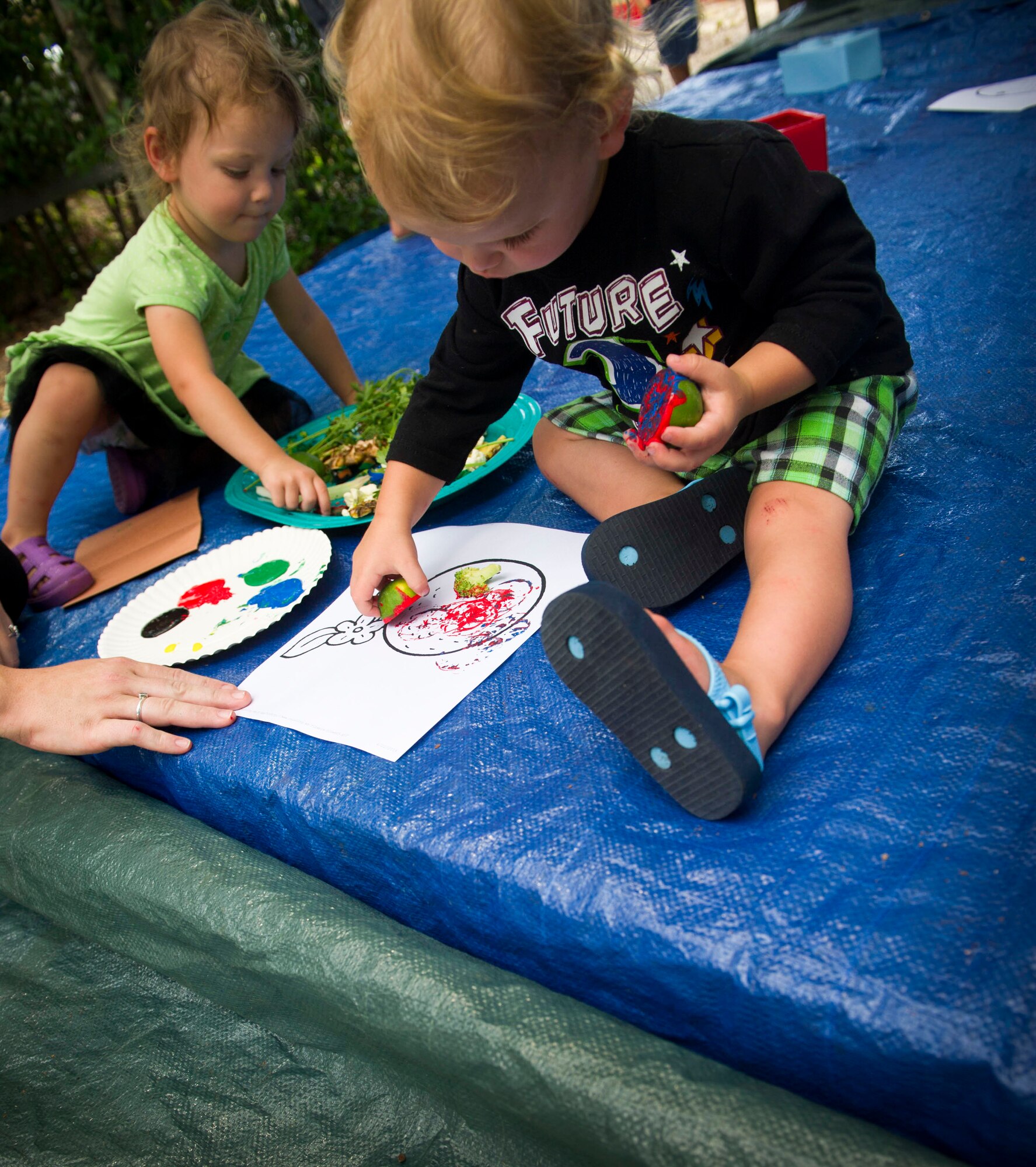 Children participate in vegetable stamp painting during a Summer Reading Program event at Hurlburt Field, Fla., June 23, 2016. During the event, children participated in physical activities while learning the importance of fruit and vegetable intake. (U.S. Air Force photo by Senior Airman Krystal M. Garrett)