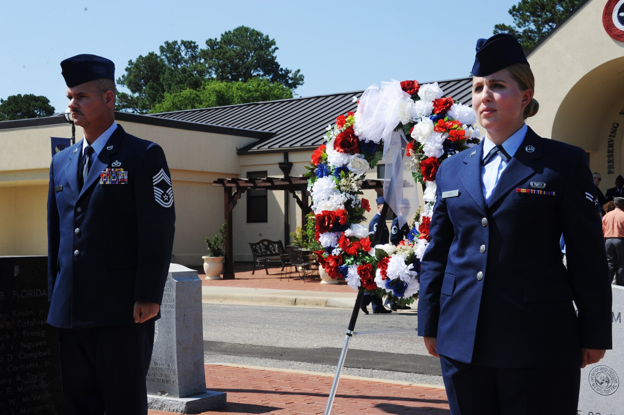 Chief Master Sgt. Derrick Grames, Air Force Life Cycle Management Business and Enterprise Systems Directorate superintendent, and Airman 1st Class Andrea Smith, Barnes Center administration support, present the wreath during the Wreath Laying Ceremony honoring the fallen Airmen of the Khobar Towers attack, June 23, 2016, Maxwell Air Force Base, Ala. Grames represented the highest ranking Airmen who was killed during the attack and Smith was representation of the youngest Airmen who was lost that day. (U.S. Air Force photo/Senior Airman Alexa Culbert)