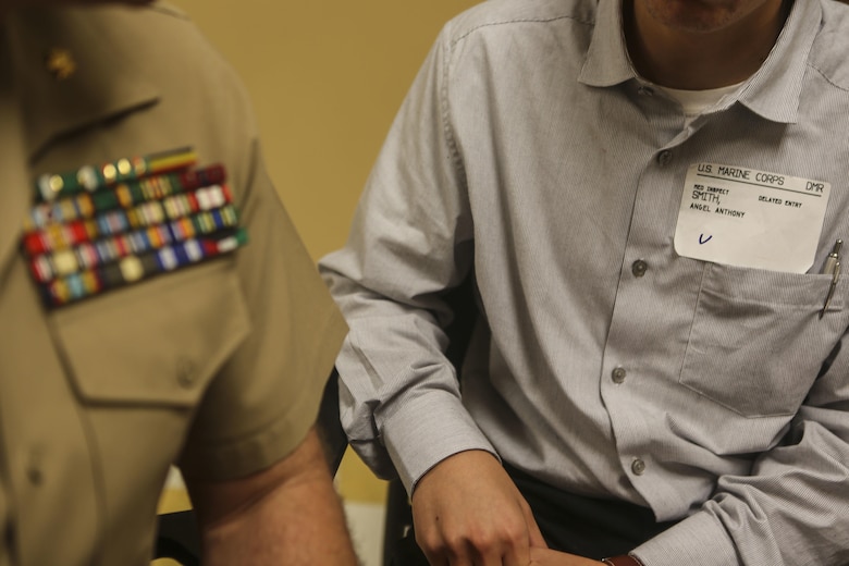 Maj. James Ramsey, the aviation ordinance officer of Marine Aviation Logistics Squadron (MAG) 11, sits with his grandson, Angel Smith, before swearing him in to the United States Marine Corps at Military Entrance Processing Station San Diego, June 14. Angel is following in his grandfather’s and uncles’ footsteps in becoming a Marine. (U.S. Marine Corps photo by Lance Cpl. Harley Robinson/Released)