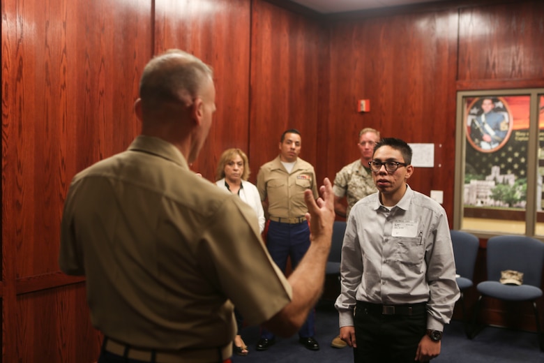 Maj. James Ramsey, left, gives a speech to his grandson, Angel Smith, and the rest of his family before swearing his grandson, Angel Smith, in to the United States Marine Corps at Military Entrance Processing Station San Diego, June 14. Minerva “Minnie” Ramsey, Sgt. Daniel “D.J.” Deleon and Sgt. Shaun Kellam all came to watch Angel be sworn in by Maj. Ramsey. (U.S. Marine Corps photo by Lance Cpl. Harley Robinson/Released)