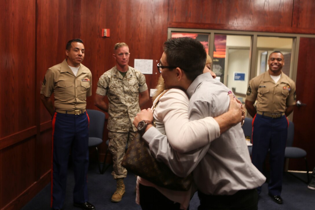Angel Smith hugs his grandmother, Minerva “Minnie” Ramsey, after being sworn in to the United States Marine Corps by his grandfather, Maj. James Ramsey, the aviation ordinance officer of Marine Aviation Logistics Squadron (MAG) 11, at Military Entrance Processing Station San Diego, June 14. Smith is following in his grandfather’s and uncles’ footsteps by becoming a Marine. (U.S. Marine Corps photo by Lance Cpl. Harley Robinson/Released)