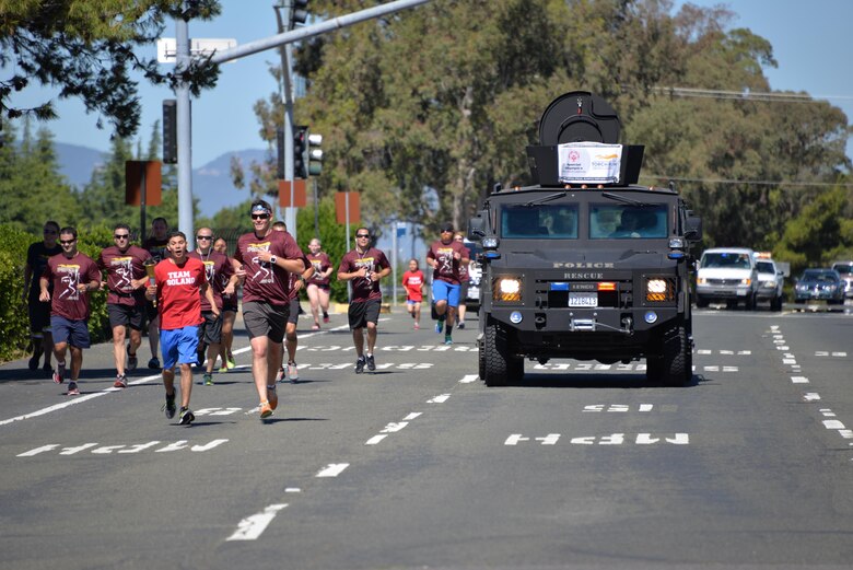 The Fairfield Police Department runs the "Flame of Hope" to the 60th Security Forces Squadron participants June 23 at Travis Air Force Base, California. The 60th SFS then ran the torch from the Main gate to the North Gate as part of the Northen California Special Olympics Summer Games at the University of California in Davis, California. 