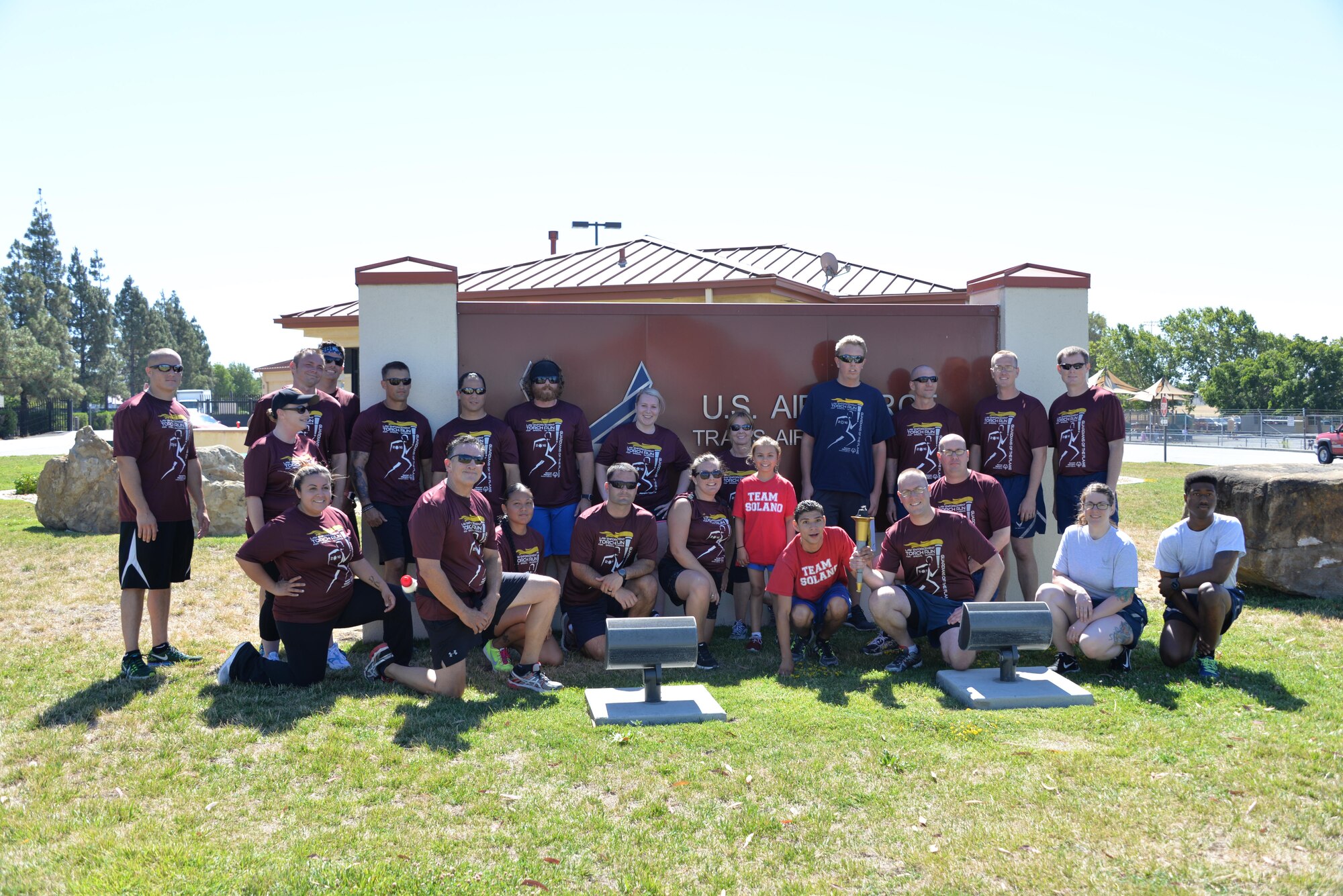 Members from the 60th Security Forces Squadron pose for a photo with the Fairfield Police Department, June 23 at Travis Air Force Base, California. The 60th SFS then ran the torch from the Main gate to the North Gate as part of the Northen California Special Olympics Summer Games at the University of California in Davis, California. 