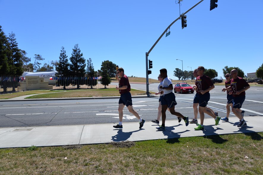 Members from the 60th Security Forces Squadron receive "The Flame of Hope," an olympic torch passed from one law enforcement agency to the next, from the Fairfield Police Department, June 23 at Travis Air Force Base, California. The 60th SFS then ran the torch from the Main gate to the North Gate as part of the Northen California Special Olympics Summer Games at the University of California in Davis, California. 
