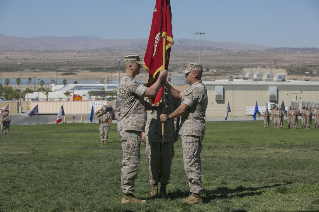 Lt. Col. Steven Murphy, right, transfers the Marine Wing Support Squadron 374 colors to Lt. Col. Christopher Siler, left, during the unit’s change of command at Lance Cpl. Torrey L. Gray Field, June 17, 2016. (Official Marine Corps photo by Cpl. Thomas Mudd/Released)