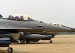 Pilots assigned to the 179th Expeditionary Fighter Squadron wait for their post-flight, end-of-runway inspection before taxing back to their parking areas, June 21, 2016, at Osan Air Base, Republic of Korea. The pilots, who are deployed from the Minnesota Air National Guard’s 148th Fighter Wing, landed after successfully completing a training sortie. 