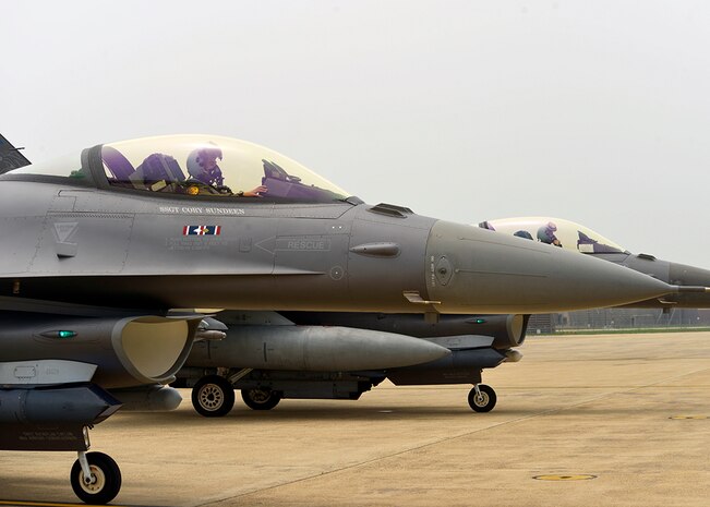 Pilots assigned to the 179th Expeditionary Fighter Squadron wait for their post-flight, end-of-runway inspection before taxing back to their parking areas, June 21, 2016, at Osan Air Base, Republic of Korea. The pilots, who are deployed from the Minnesota Air National Guard’s 148th Fighter Wing, landed after successfully completing a training sortie. 