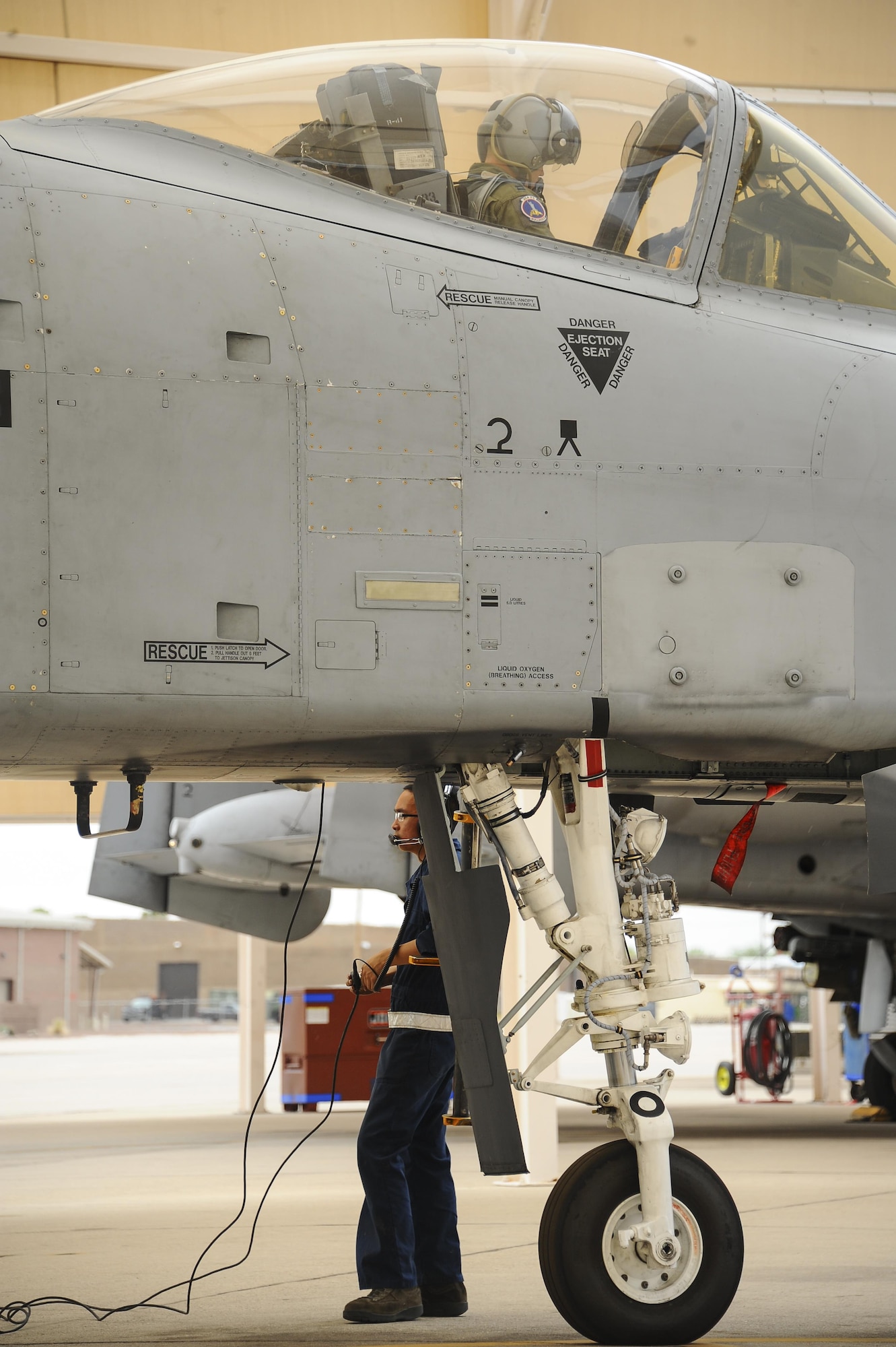 U.S. Air Force Senior Airman Andy Bui, 355th Aircraft Maintenance Squadron A-10C Thunderbolt II crew chief, communicates with an A-10 pilot assigned to the 354th Fighter Squadron, on the flightline at Davis-Monthan Air Force Base, Ariz., June 23, 2016. The 355th AMXS provides safe and properly configured aircraft in order to meet mission requirements for three squadrons.  (U.S. Air Force photo by Airman 1st Class Mya M. Crosby/Released)