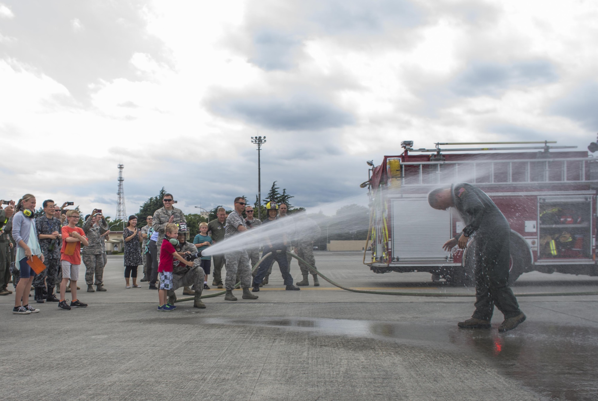 Col. Douglas DeLaMater, 374th Airlift Wing commander, plays with his daughter, Danica, after his final flight at Yokota Air Base, Japan, June 14, 2016. After 24 years of service, including 2,500 flight hours, DeLaMater is preparing to retire and spend more time with his family. (U.S. Air Force photo by Airman 1st Class Elizabeth Baker/Released)