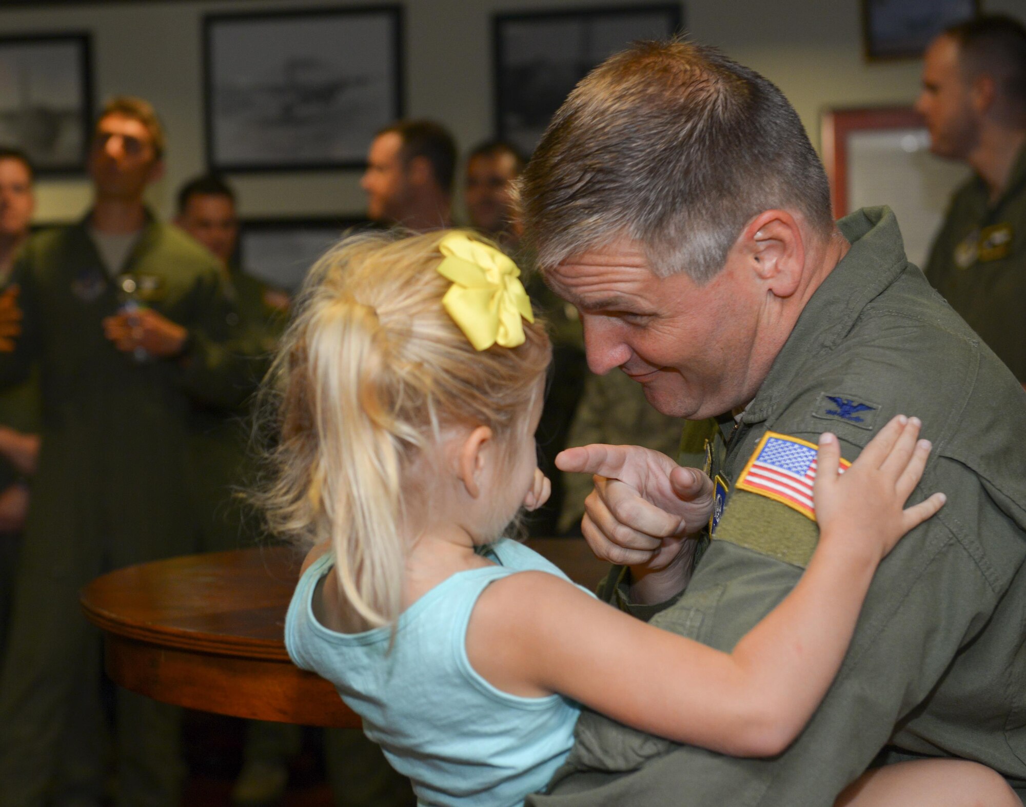 Col. Douglas DeLaMater, 374th Airlift Wing commander, plays with his daughter, Danica, after his final flight at Yokota Air Base, Japan, June 14, 2016. After 24 years of service, including 2,500 flight hours, DeLaMater is preparing to retire and spend more time with his family. (U.S. Air Force photo by Airman 1st Class Elizabeth Baker/Released)