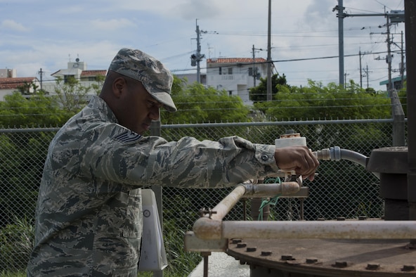U.S. Air Force Tech. Sgt. Camarius Johnson, 18th Logistics Readiness Squadron fuels quality assurance evaluator, performs an organizational tank inspection June 21, 2016, at Kadena Air Base, Japan. Part of the inspection includes checking movement of all valves and prevention of rust formation. (U.S. Air Force photo by Airman 1st Class Lynette M. Rolen)