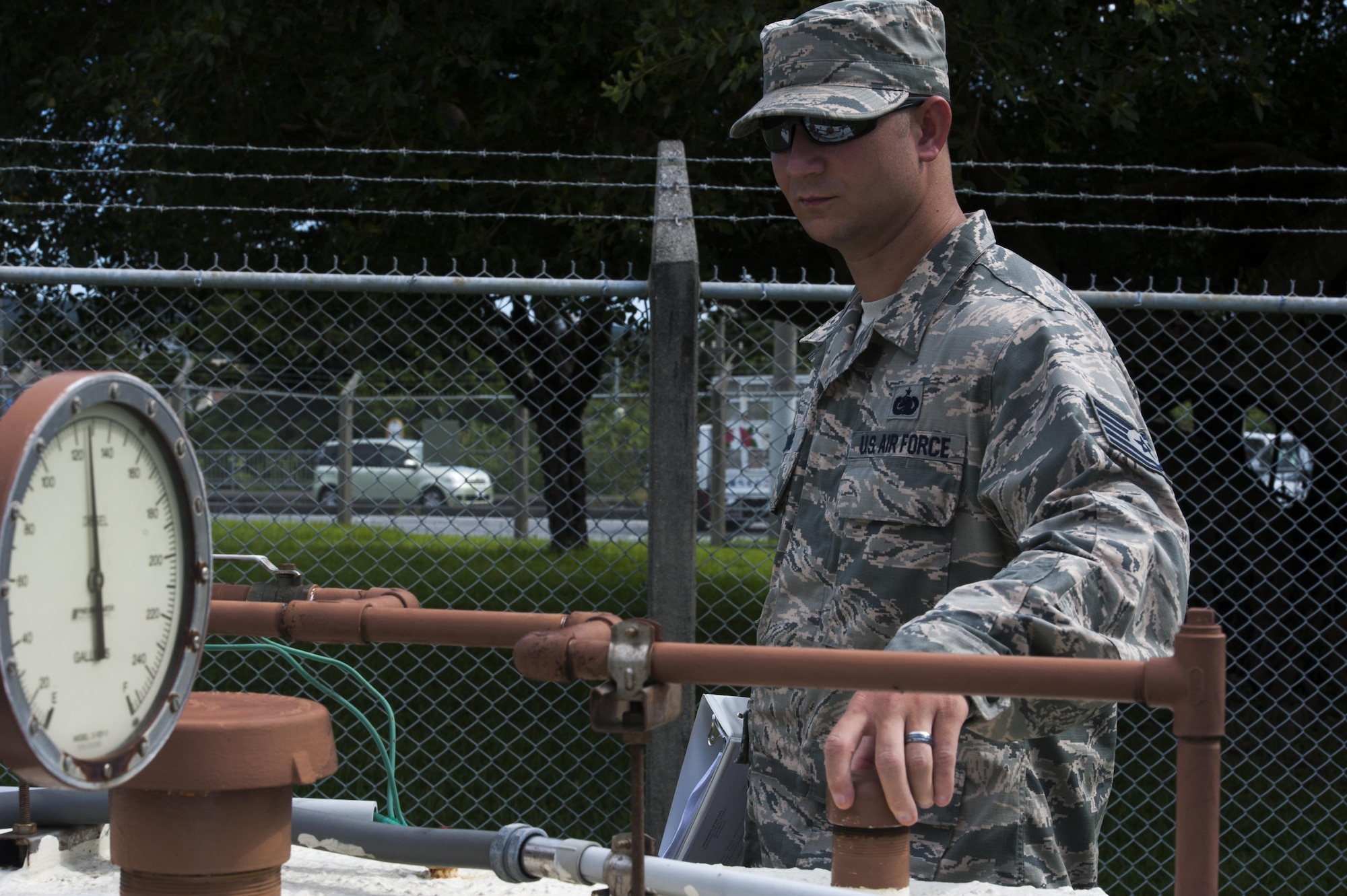 U.S. Air Force Tech. Sgt. Matthew Young, 18th Logistics Readiness Squadron fuels quality assurance evaluator, conducts an organizational tank inspection June 21, 2016, at Kadena Air Base, Japan. The inspection included checking the safety of tanks for the surrounding environment and security from tampering. The tanks help fuel a lift station, which prevents flooding in housing and the local community. (U.S. Air Force photo by Airman 1st Class Lynette M. Rolen)
