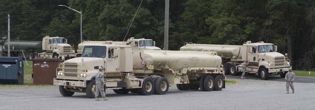 FORT A.P. HILL, Va. - Soldiers of 348th Transportation Company ground guide their trucks into the motor pool after completing their mission to deliver fuel to Langley Air Force Base, Va. About 700 Army Reserve Soldiers of the 745th Quartermaster Group provide fuel and water to various locations during the 2016 Quartermaster Liquid Logistics Exercise. (U.S. Army photo by Spc. Gary R. Yim, 372nd Mobile Public Affairs Detachment)