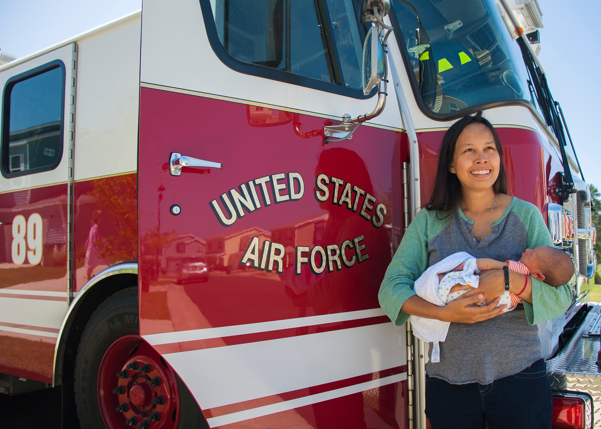 Leana Zimmerman, smiles as she holds her newborn, Luca Zimmerman during a visit with firefighters June 20 at Eglin Air Force Base, Fla. The Zimmermans son, Luca, was born in their home on base with the help of firefighters in the early morning hours of June 13. (U.S. Air Force photo/Ilka Cole) 