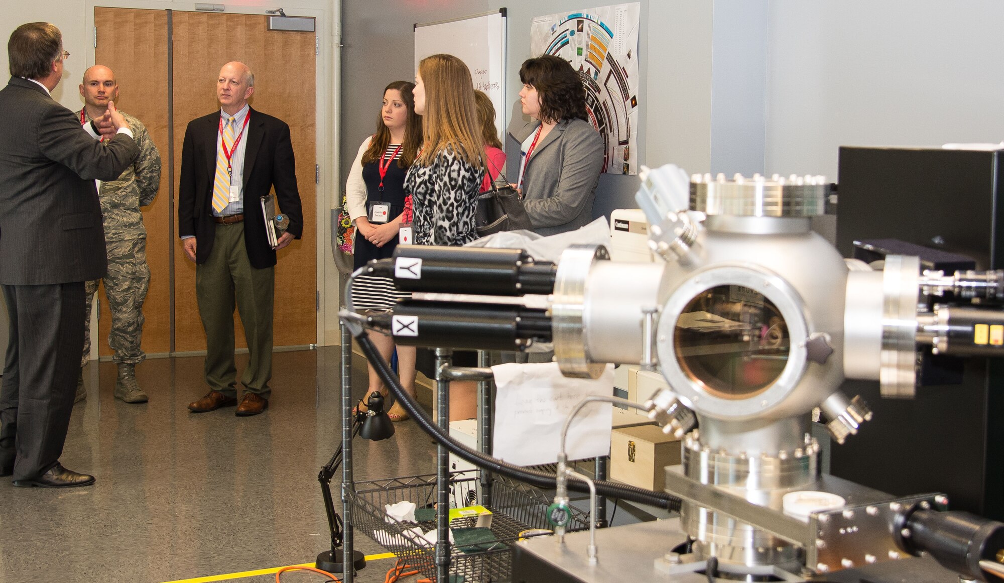 Peter Boynton, the George J. Kostas Research Institute for Homeland Security CEO, speaks to a group of Hanscom Community Partnership Committee members in KRI’s materials and devices laboratory during a facility tour in Burlington, Mass., June 16. Hanscom and KRI recently signed an Education Partnership Agreement, which grants new research and educational collaboration opportunities for the Air Force Life Cycle Management Center programs at Hanscom. (U.S. Air Force photo by Walter Santos)