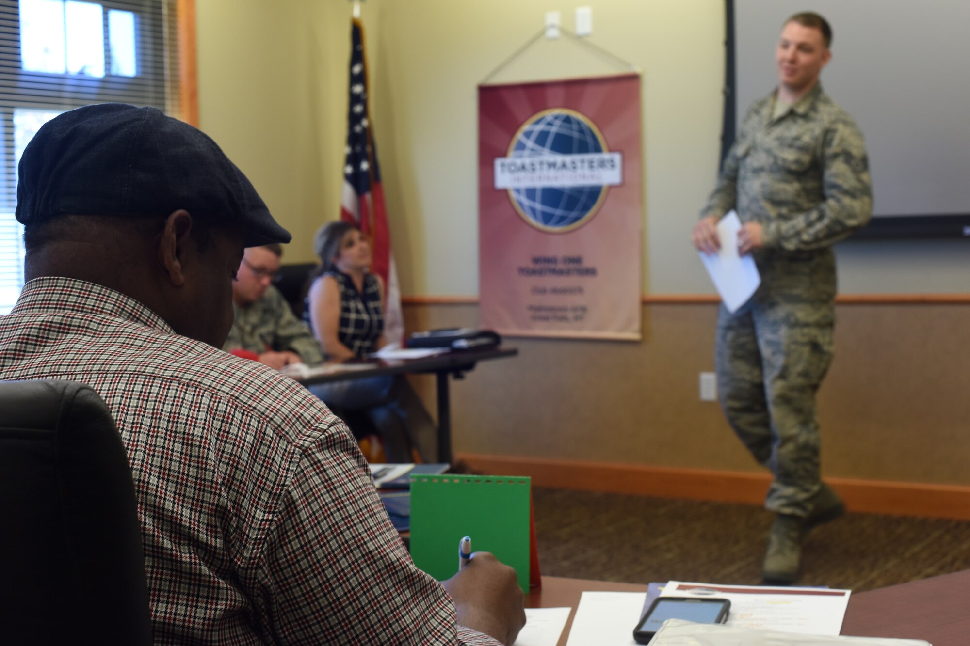 A member of the Wing One Toastmasters Club keeps time for another individual while he gives an icebreaker speech June 22, 2016, at Malmstrom Air Force Base, Mont. The Wing One Toastmasters Club is a way to get past the fear of public speaking, while networking and having fun with other people across a wide spectrum. (U.S. Air Force photo/Senior Airman Jaeda Tookes)

