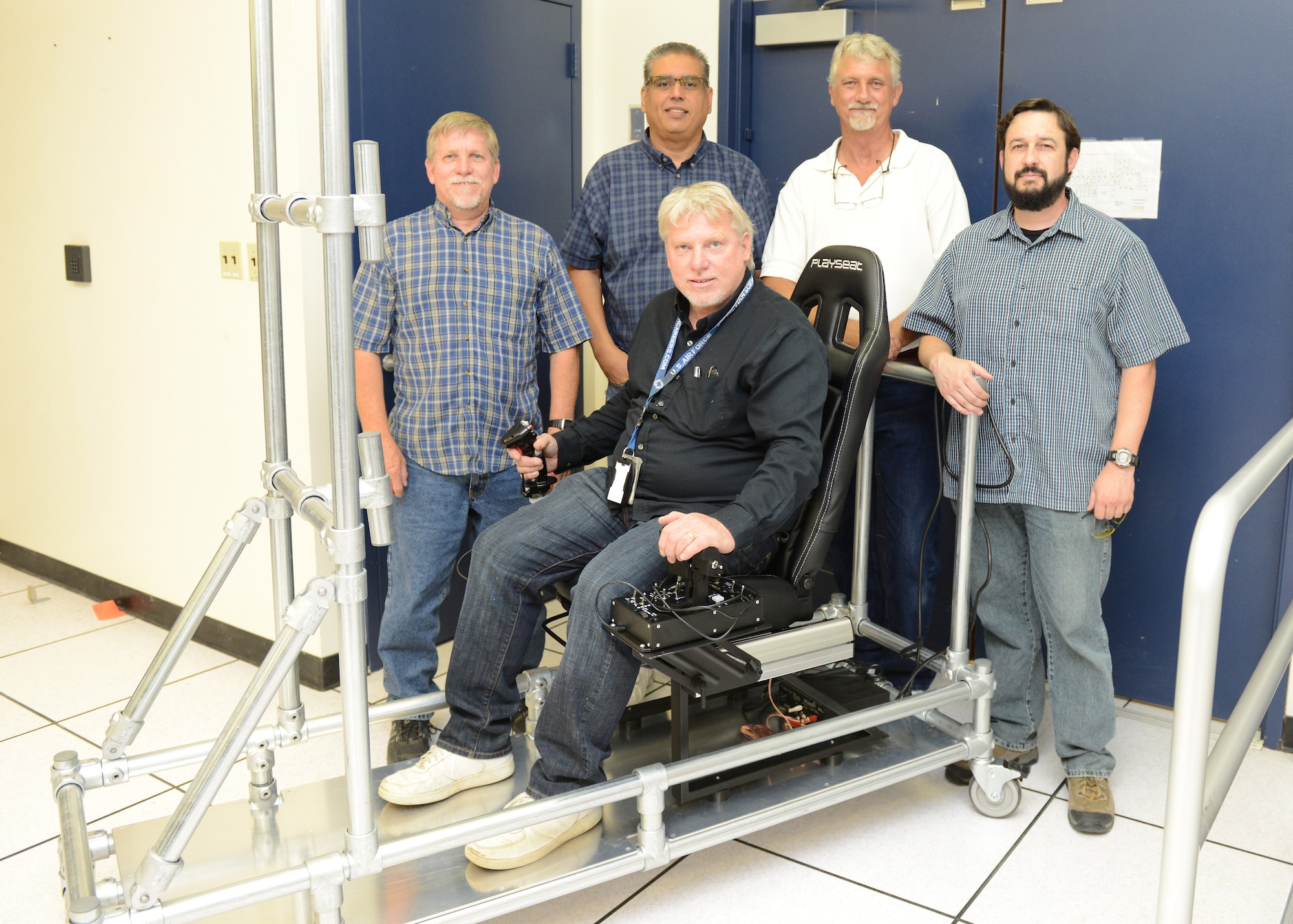 The Portable Manned Interactive Cockpit being built by members of the 772nd Test Squadron should be completed next month. The innovation team from the 772nd TS are (back left to right) Curtis Westfall, Victor Cruz, Gary Johnson, Kevin Dolber and Orion Westfall (seated). (U.S. Air Force photo by Kenji Thuloweit)