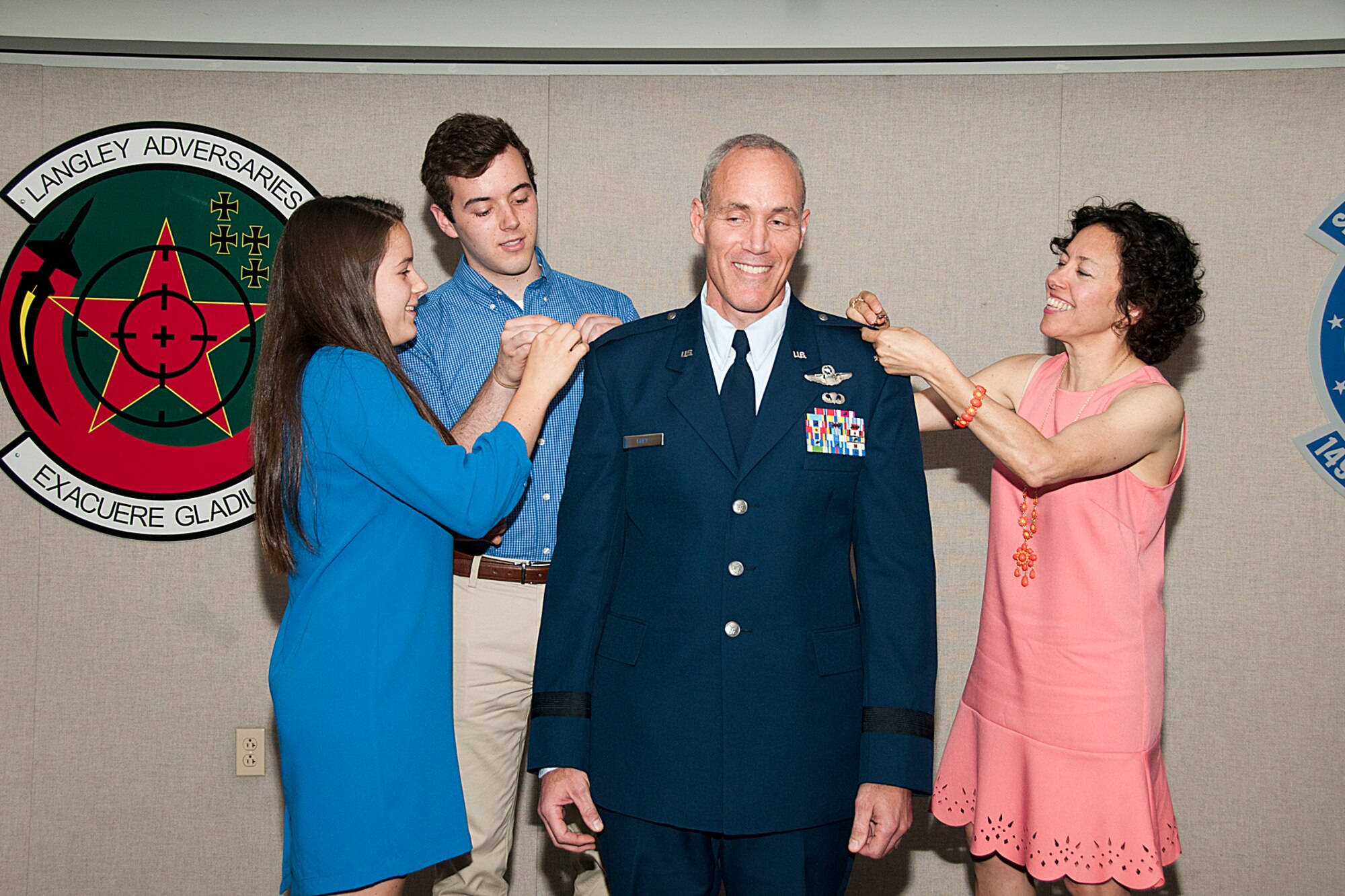 U.S. Air Force Col. Robert J. Grey, Virginia Assistant Adjutant General, Air and Strategic Initiatives, is promoted to brigadier general June 16, 2016, at Joint Base Langley-Eustis, 149th Fighter Wing, Hampton, Virginia. His wife, Francine, son, Bobby, and daughter, Samantha, pin on his new rank during his promotion ceremony. (U.S. Air National Guard photo by Master Sgt. Carlos J. Claudio)