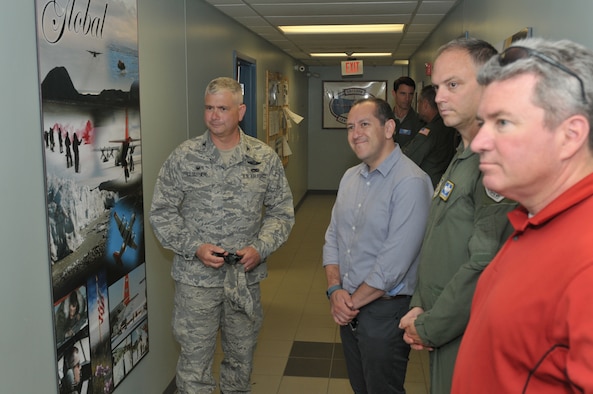Col. Shawn Clouthier (left), 109th Airlift Wing commander, shows Gabe Camarillo, Brig. Gen. Bradley Swanson and Chris Swadener some photos displayed showcasing the wing's mission during a tour of Stratton Air National Guard Base, New York, on June 22, 2016. Camarillo is the Assistant Secretary of the Air Force for Manpower and Reserve Affairs; Swanson is the Director of Plans and Programs at the Air National Guard Readiness Center; and Swadener is the Associate Director of Operations for the Air National Guard. (U.S. Air National Guard photo by Staff Sgt. Benjamin German/Released)