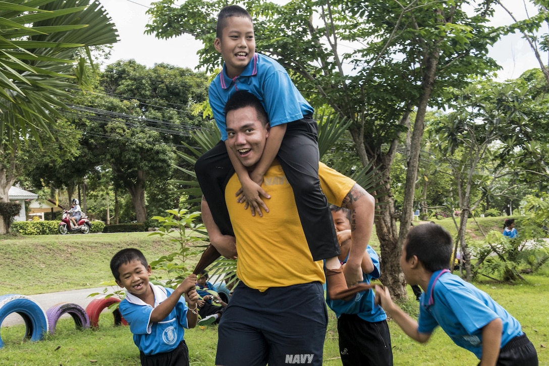 Navy Seaman Andre Galit plays with children from Chuksamet School during a community service event to support Cooperation Afloat Readiness and Training, an annual maritime exercise, in Thailand, June 22, 2016. Navy photo by Petty Officer 2nd Class Joshua Fulton