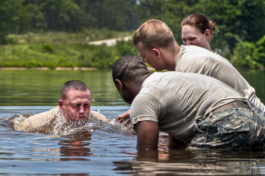 A soldier surfaces after securing a water pump for a tactical water purification system during the annual Quartermaster Liquid Logistics Exercise at Fort Bragg, N.C., June 14, 2016. Army photo by Staff Sgt. Dalton Smith