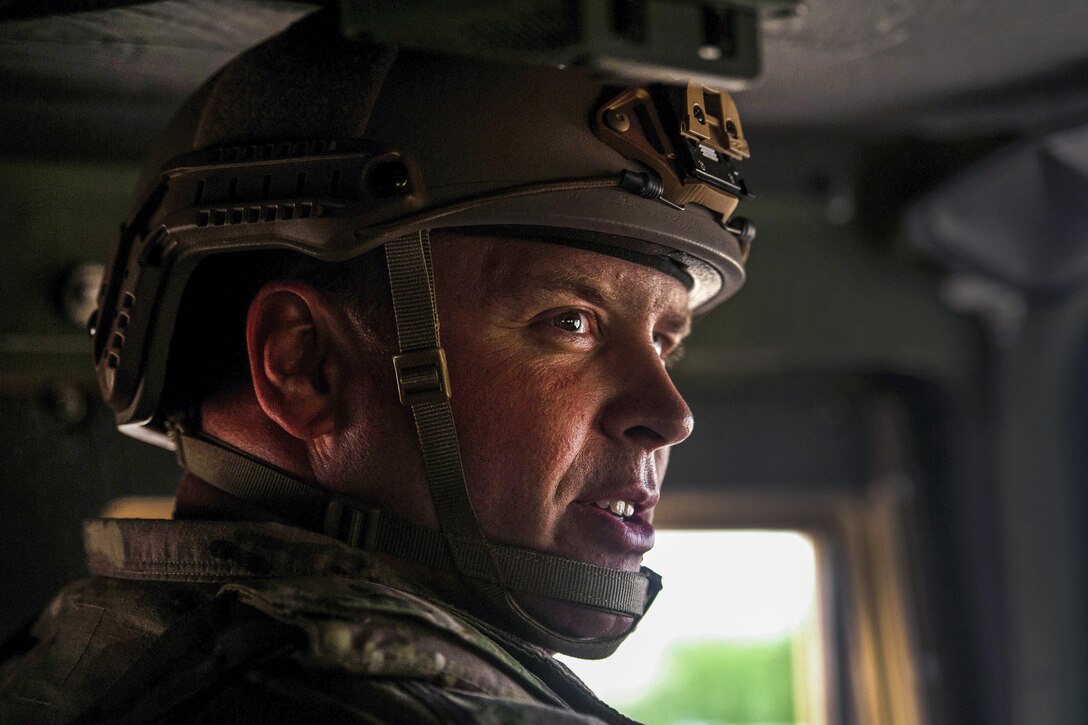 Air Force Maj. Aaron Cook speaks with airmen inside a tactical vehicle as they drive out to a landing strip site during Exercise Swift Response 16 at Hohenfels, Germany, June 16, 2016. Cook is a liaison officer assigned to the 621st Mobility Support Operations Squadron Air Mobility. Air Force photo by Master Sgt. Joseph Swafford