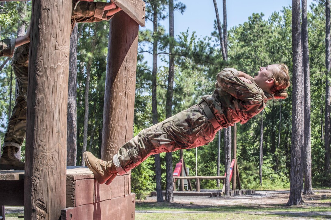 A soldier in basic training falls several feet out of a training obstacle onto a mat during the confidence course at Fort Jackson, S.C., June 22, 2016. Army photo by Sgt. 1st Class Brian Hamilton