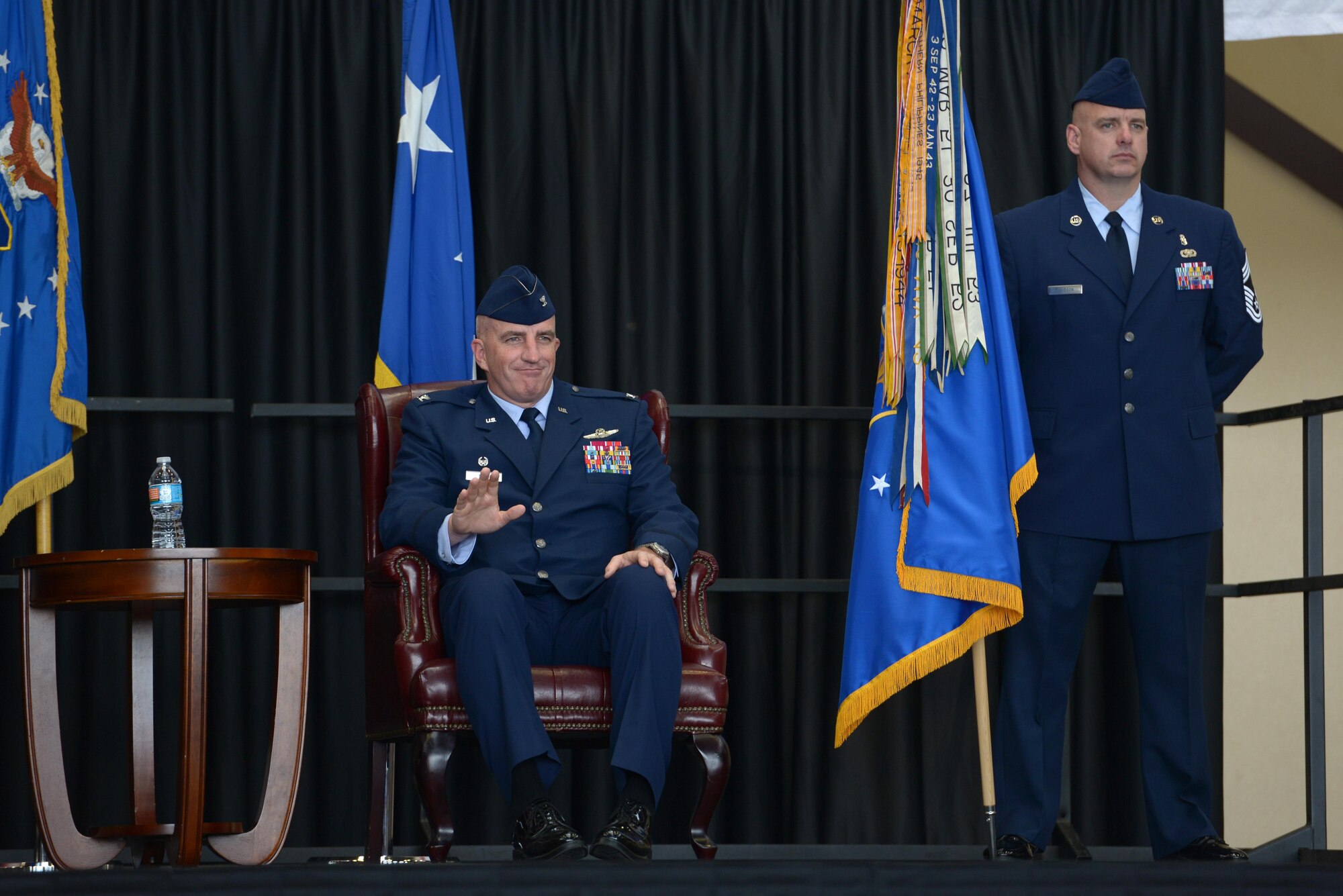Col. Kenneth Moss, 374th Airlift Wing incoming commander, waves to the audience during the official wing change of command at Yokota Air Base, Japan, June 24, 2016. Moss praised the 374 AW for their accolades and mentioned his excitement to continue to build on their excellent reputation and the strong U.S.-Japan partnership. (U.S. Air Force photo by Staff Sgt. Cody H. Ramirez/Released)