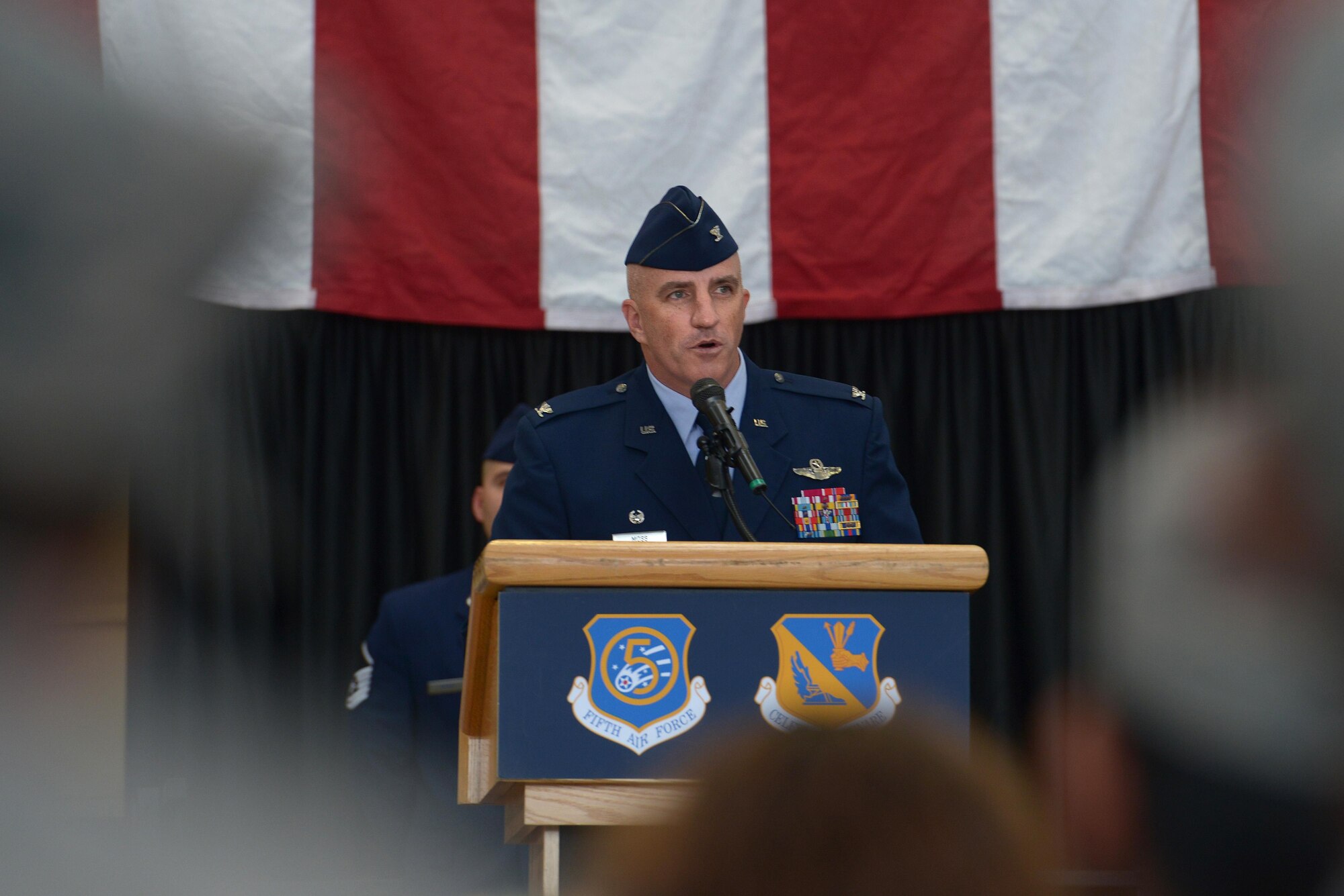Col. Kenneth Moss, 374th Airlift Wing incoming commander, speaks to members of the audience during the official wing change of command at Yokota Air Base, Japan, June 24, 2016. Moss praised the 374 AW for their accolades and mentioned his excitement to continue to build on their excellent reputation and the strong U.S.-Japan partnership. (U.S. Air Force photo by Staff Sgt. Cody H. Ramirez/Released)