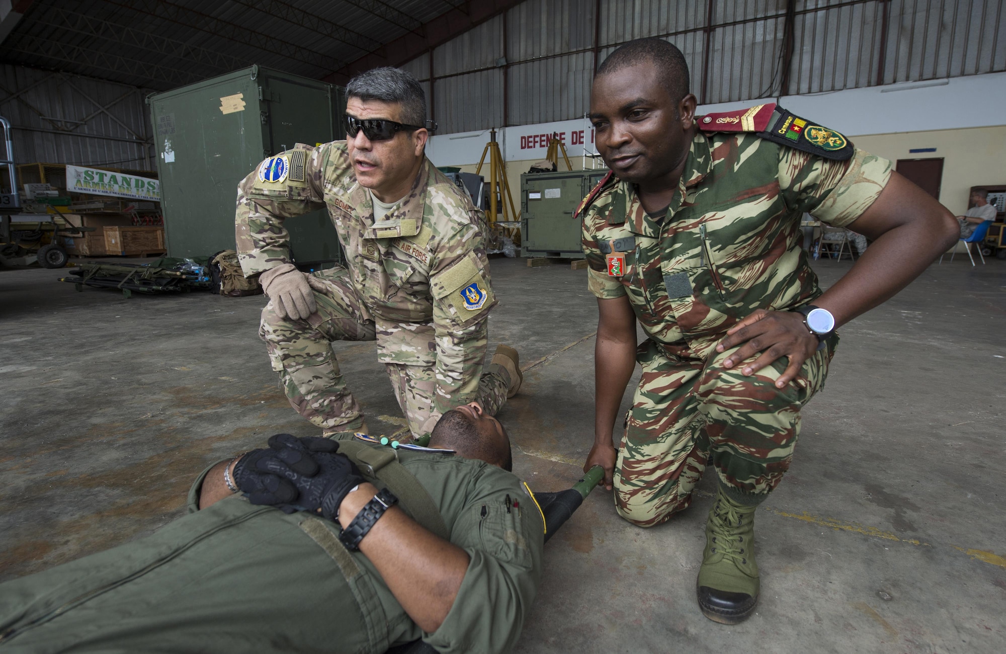 U.S. Air Force Reserve MSgt. Johnny Gomez (left), an aeromedical evacuation technician with the 315th Aeromedical Evacuation Squadron, and a member of the Cameroonian Armed Forces transport a simulated casualty during aeromedical evacuation training at this year’s Central Accord exercise in Libreville, Gabon on June 14, 2016. U.S. Army Africa’s exercise Central Accord 2016 is an annual, combined, joint military exercise that brings together partner nations to practice and demonstrate proficiency in conducting peacekeeping operations. (DoD News photo by TSgt Brian Kimball)