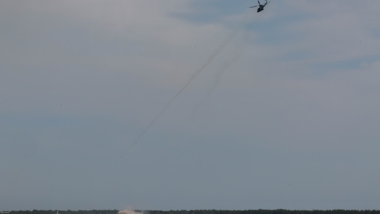 A UH-1Y Venom utility helicopter provides close air support during a two-day, joint tactical air control exercise at Marine Corps Base Camp Lejeune, N.C., June 20-21, 2016. Marine students in the tactical air control party course were required to identify enemy strongholds, plot coordinates, and request air support while artillery and mortars suppressed the positions.