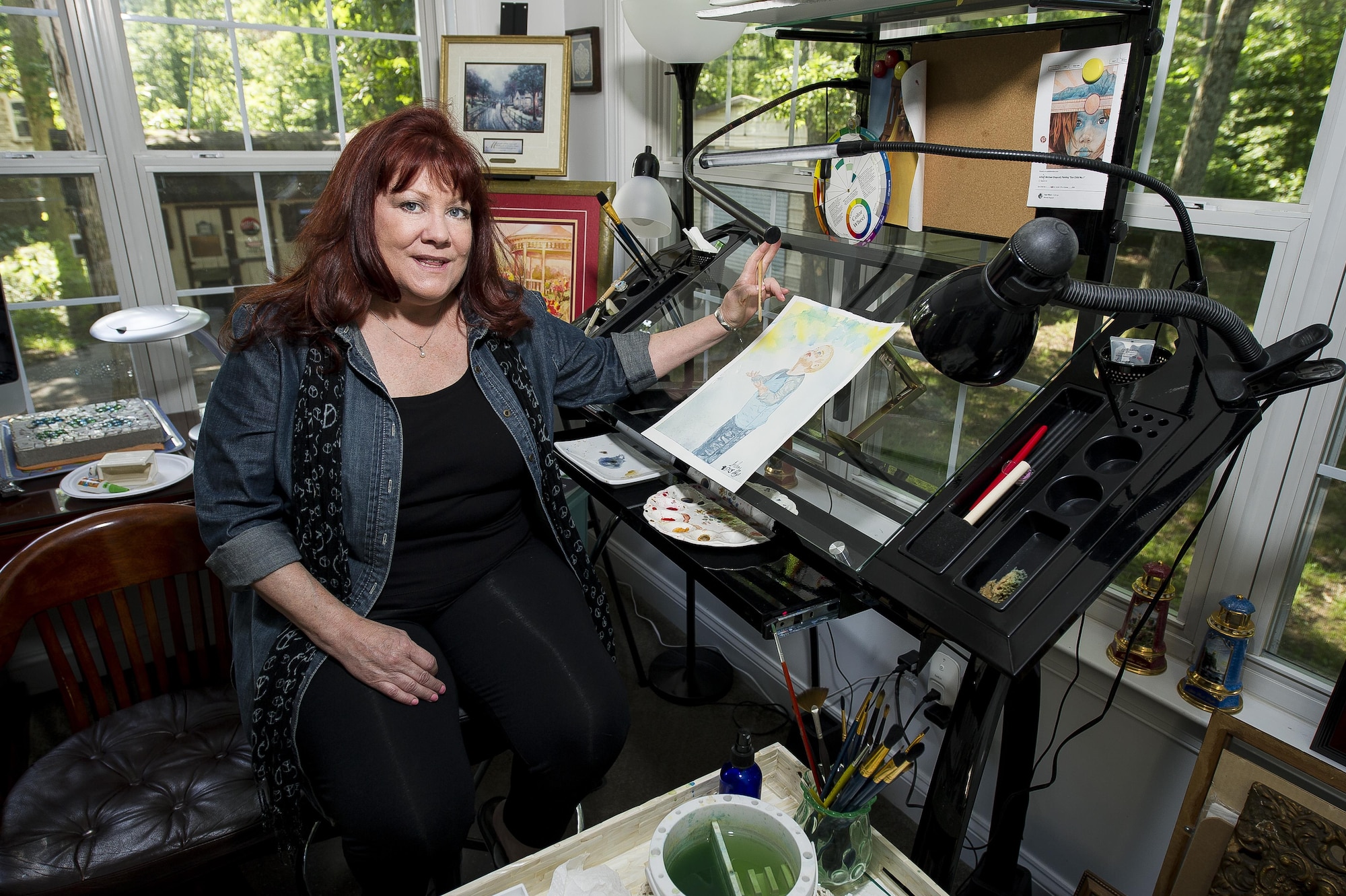 Selena Zuhoski sits inside her art studio at her home in Maryland on June 10, 2016. Zuhoski was in a recreational building when terrorists exploded a truck in front of Bldg. 131 of the Khobar Towers complex in Dharan, Saudi Arabia, on June 25, 1996. Zuhoski and a group of people were among the first to help victims following the explosion, which killed 19 Airmen and injured more than 350 people. Art has been therapeutic for Zuhoski in dealing with her post-traumatic stress disorder from the attack. (U.S. Air Force photo/Staff Sgt. Christopher Gross)