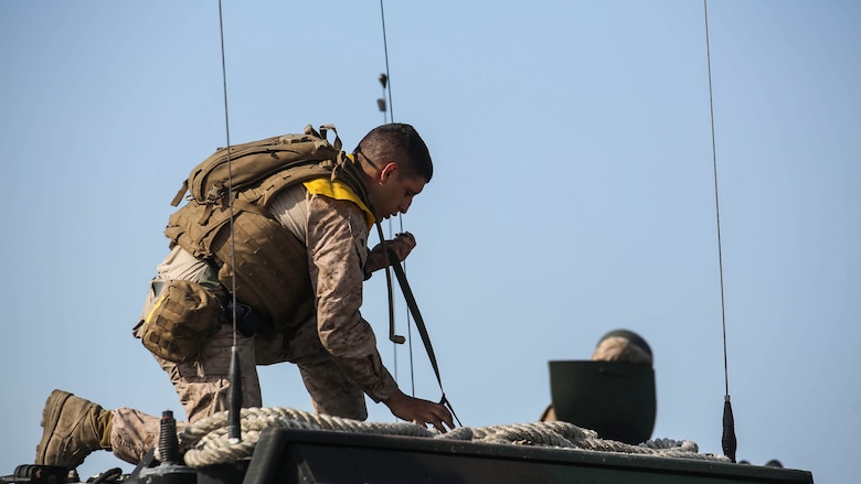 A Marine with Charlie Company, 4th Assault Amphibian Battalion secures equipment before conducting amphibious operations at Marine Corps Camp Lejeune, N.C., June 22, 2016. The company, based in Galveston, Texas, arrived in Camp Lejeune for a two-week annual training package. 