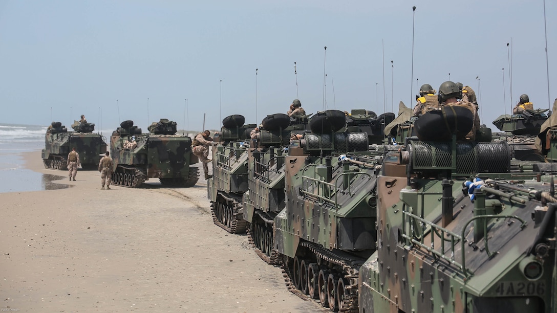 Marines with Charlie Company, 4th Assault Amphibian Battalion move down the beach during water operations at Marine Corps Base Camp Lejeune, N.C., June 22, 2016. The company, based in Galveston, Texas, arrived in Camp Lejeune for a two-week annual training package. 