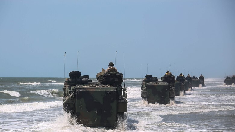 Marines with Charlie Company, 4th Assault Amphibian Battalion move down the beach during water operations at Marine Corps Base Camp Lejeune, N.C., June 22, 2016. The company, based in Galveston, Texas, arrived in Camp Lejeune for a two-week annual training package. 