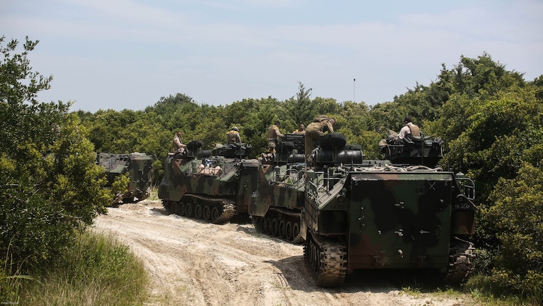 Marines with Charlie Company, 4th Assault Amphibian Battalion halt before a river crossing during water operations at Marine Corps Base Camp Lejeune, N.C., June 22, 2016. The company, based in Galveston, Texas, conducted operations in land and sea to prepare for their upcoming Unit Deployment Program to Okinawa.