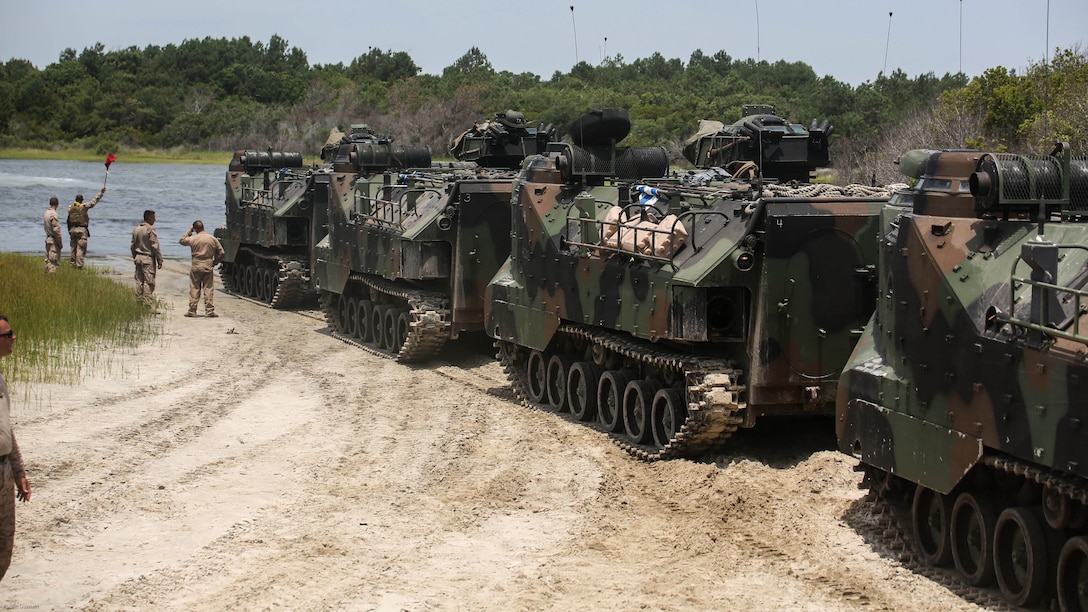 Marines with Charlie Company, 4th Assault Amphibian Battalion halt before a river crossing during water operations at Marine Corps Base Camp Lejeune, N.C., June 22, 2016. The company, based in Galveston, Texas, conducted operations in land and sea to prepare for their upcoming unit deployment program to Okinawa. 