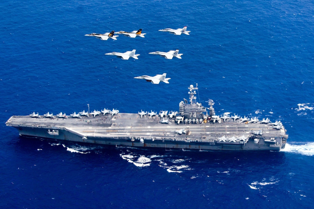 Aircraft from Carrier Air Wing 5 and Carrier Air Wing 9 pass in formation above the Nimitz-class aircraft carrier USS John C. Stennis in the Philippine Sea, June 19, 2016. Navy photo by Lt. Steve Smith