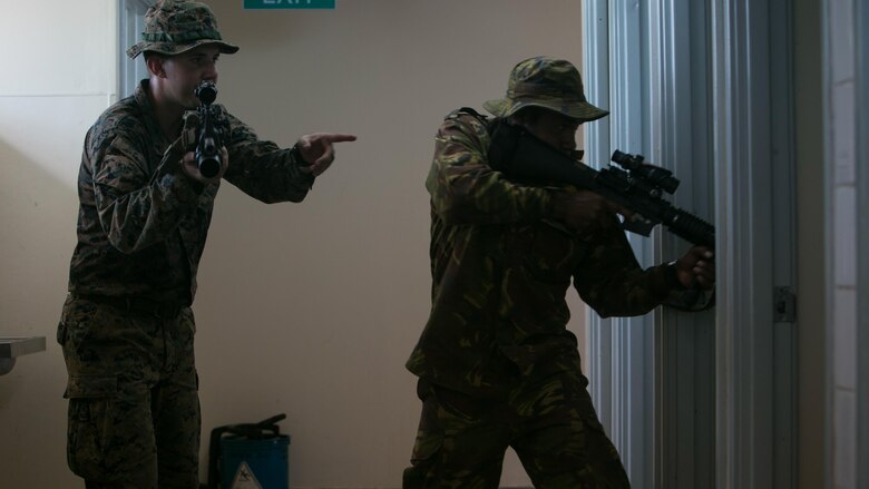Lance Cpl. Nathan H. Steed demonstrates room-clearing techniques while training with a Papua New Guinean soldier, June 19, 2016, at Taurama Barracks, during Exercise Koa Moana. This is the first exercise for U.S. Marines and service members of the Papua New Guinea Defence Force.