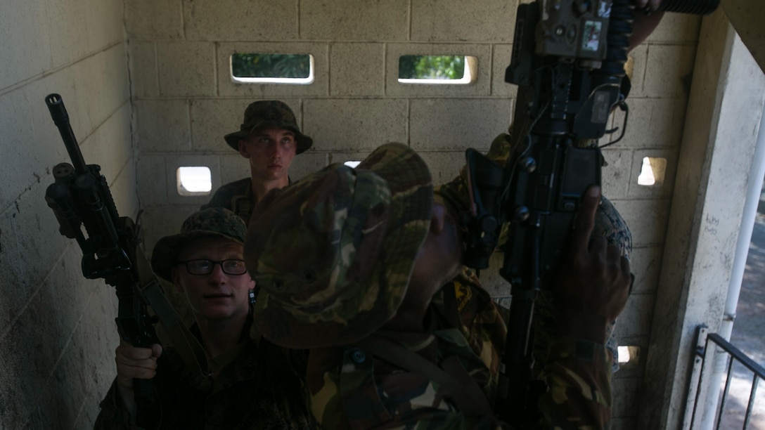 Lance Cpl. Jacob W. Anderson practices clearing a stairwell with a fire team made of Marines and soldiers with the Papua New Guinea Defence Force, June 19, 2016, at Taurama Barracks, as part of Exercise Koa Moana. Koa Moana, the first exercise between U.S. Marines and the PNGDF directly, is designed to increase interoperability and relations by sharing infantry, engineering, medical and law enforcement capabilities. 