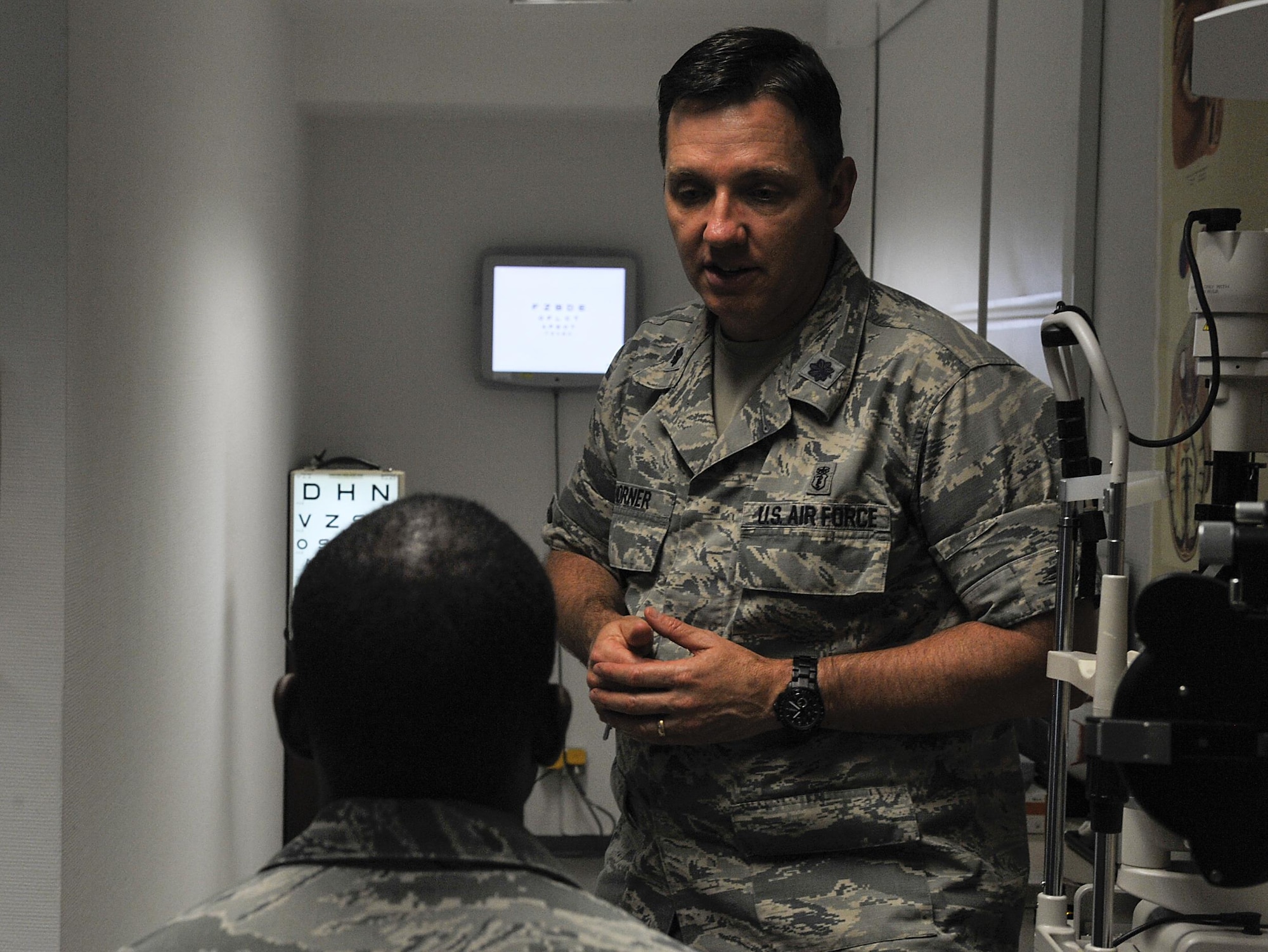 Lt. Col. Neil Horner, 86th Aerospace Medicine Squadron optometry flight commander (right), speaks to Senior Airman Jonathan Robins, 1st Combat Communications Squadron maintenance operations center technician, about his eye health June 23, 2016, at Ramstein Air Base, Germany. The clinic is the largest in U.S. Air Forces in Europe, offering assistance and care to more than 54,000 Americans. (U.S. Air Force photo/Senior Airman Larissa Greatwood)