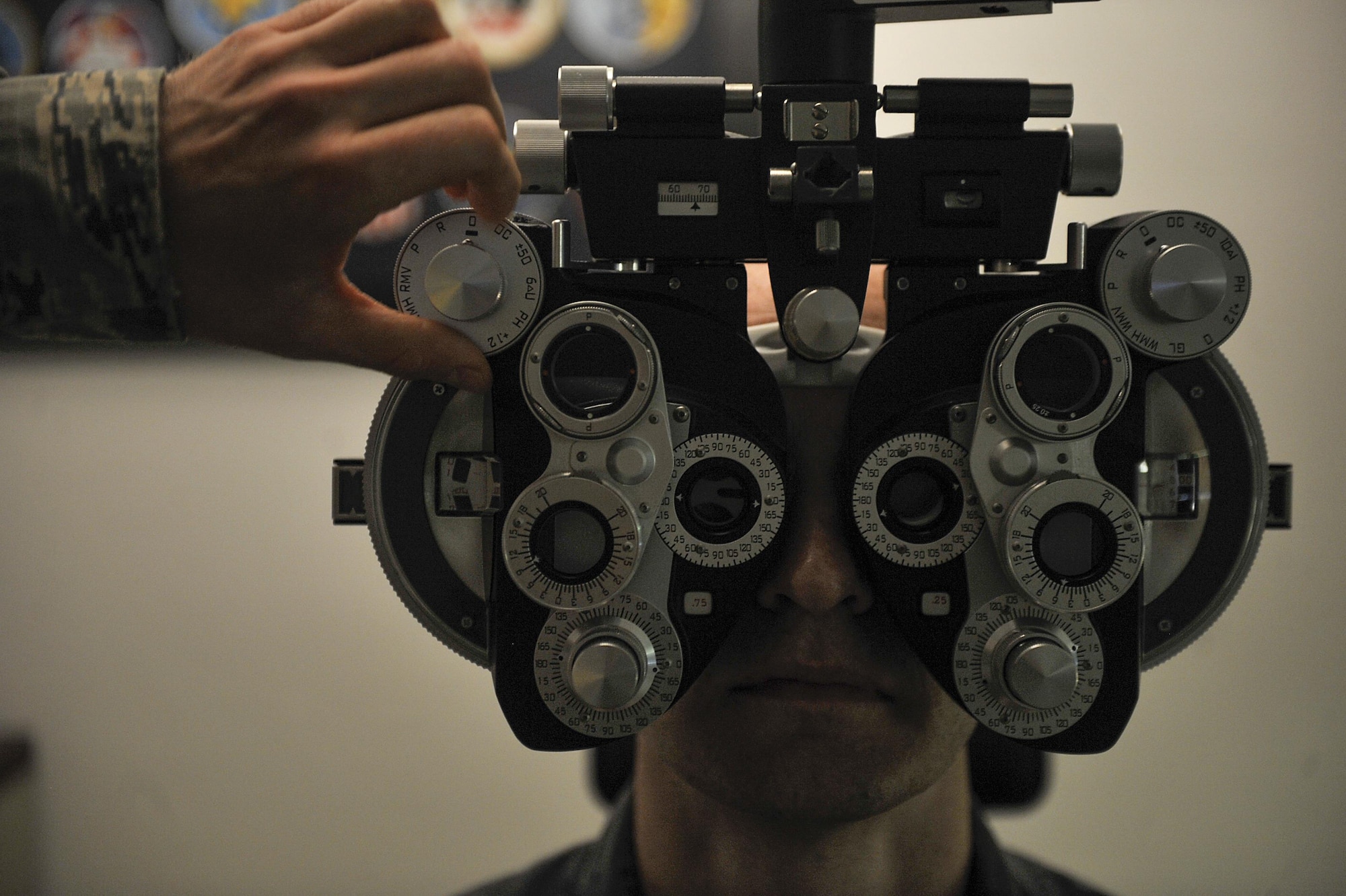 A patient looks through a phoropter during an optometry exam June 23, 2016, at Ramstein Air Base, Germany. The 86th Aerospace Medicine Squadron optometry clinic supports roughly 54,000 Americans, making it the largest American population outside of the continental U.S. (U.S. Air Force photo/Senior Airman Larissa Greatwood)