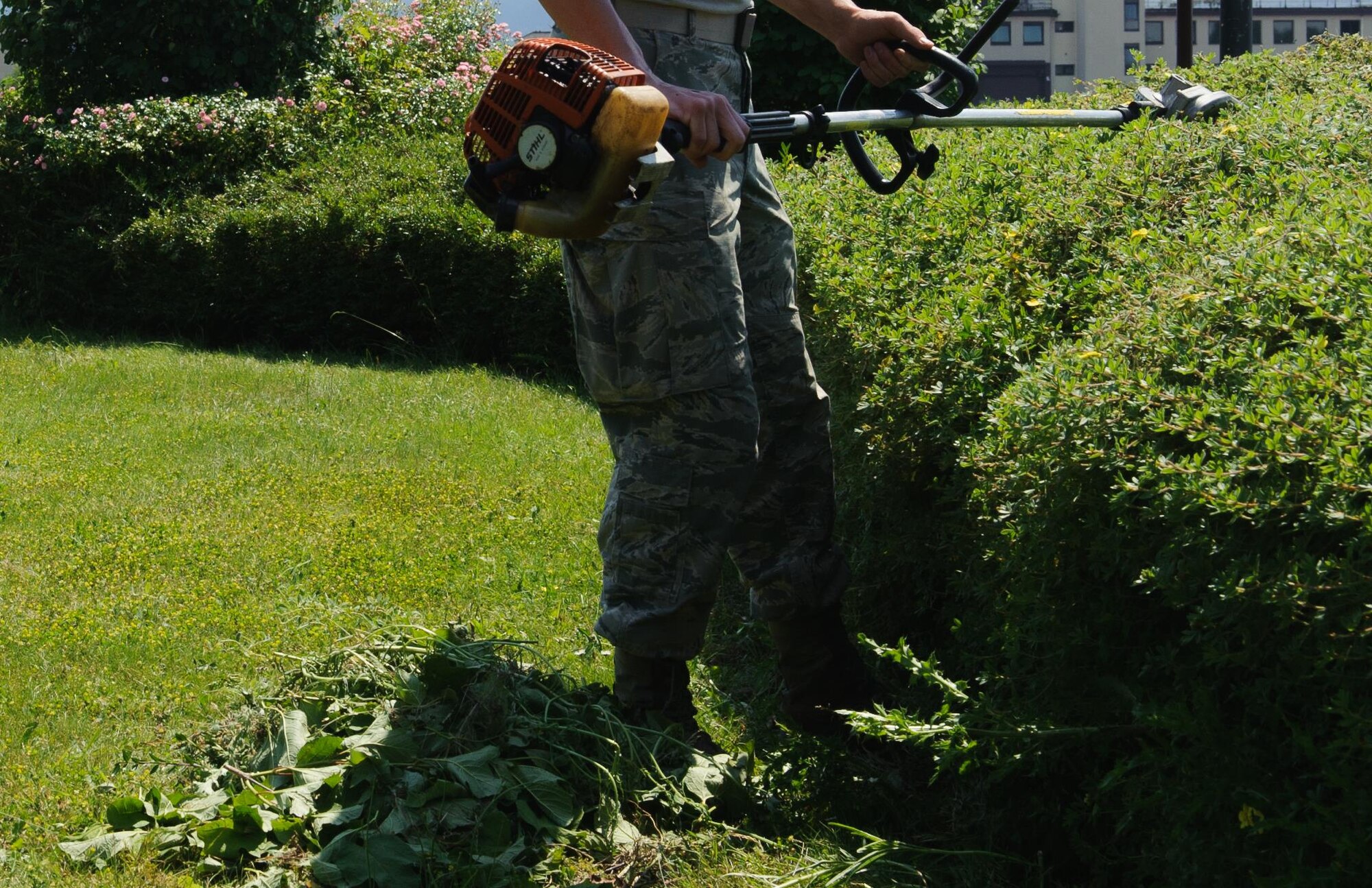 An Airman from the 786th Civil Engineering Squadron shreds through the excess of a bush June 24, 2016, at Ramstein Air Base, Germany. Throughout the year, Ramstein maintains its high standard of cleanliness through the help of Airmen from the 786th CES and other squadrons maintaining base morale. (U.S. Air Force photo/Airman 1st Class Lane T. Plummer)