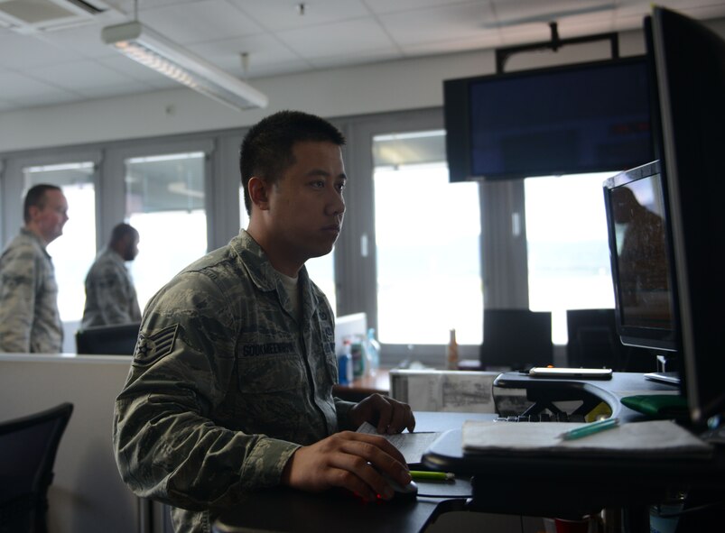 Staff Sgt. Srun Sookmeewiriya, 313th Expeditionary Operations Support Squadron command post controller, works inside the air mobility control center at Ramstein Air Base, Germany, June 21, 2016. The 313th EOSS is responsible for the command and control of all 18th Air Force mobility aircraft that transports through Ramstein. (U.S.  Air Force photo/ Airman 1st Class Joshua Magbanua)


