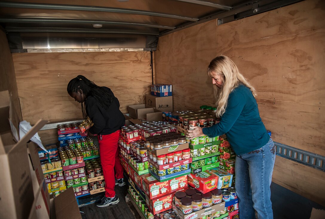 Defense Supply Center Columbus personnel stack donations of canned foods during the annual Feds Feed Families campaign. Each year, donations from federal employees support the Mid-Ohio Food Bank's Operation Feed food drive, bringing essential items to central Ohio families in need.